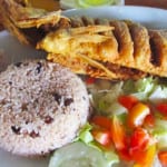 typical Panamanian meal fried corvina with arrows con wand and fresh salad