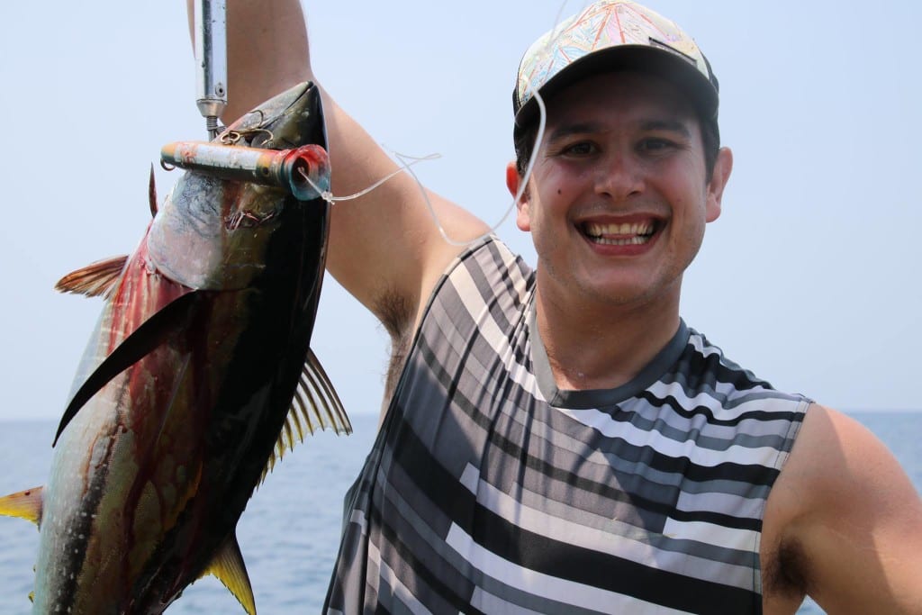 guest with all smiles after he catches his first tuna while on vacation in Panama
