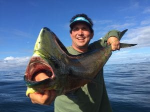 angler poses with dorado caught while fishing tuna coast panama