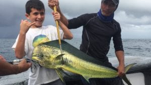 captain miguel and young guest with mahe mahe caught fishing Coiba Island Panama