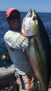 captain miguel with large tuna caught while with guests on their panama fishing vacation during try season