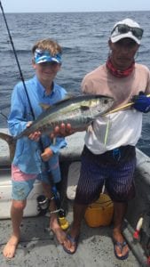 captain miguel with young guest posing with tuna while on staying at panama fishing lodge