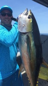 guest with yellowfin after long fight while tunas were boiling right next to the boat