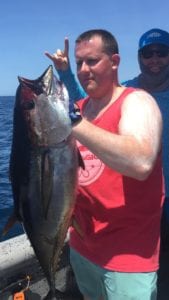 guests messing around while posing with yellowfin tuna caught while on panama fishing vacation