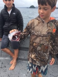 kid shows live bait that was eaten whole by something big while fishing in panama