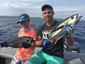 two young guests with their nice tunas caught while on panama fishing vacation