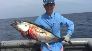 young guest on panama fishing vacation catching tuna