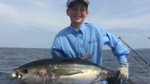 young guest with tuna caught while staying at panama fishing lodge