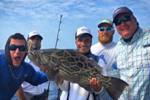 all the boys in the shot with the broom tail grouper caught while on fishing vacation to panama