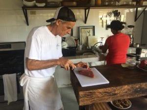 chefs working slicing fresh tuna steaks for guests at the el rio negro lodge in Panama